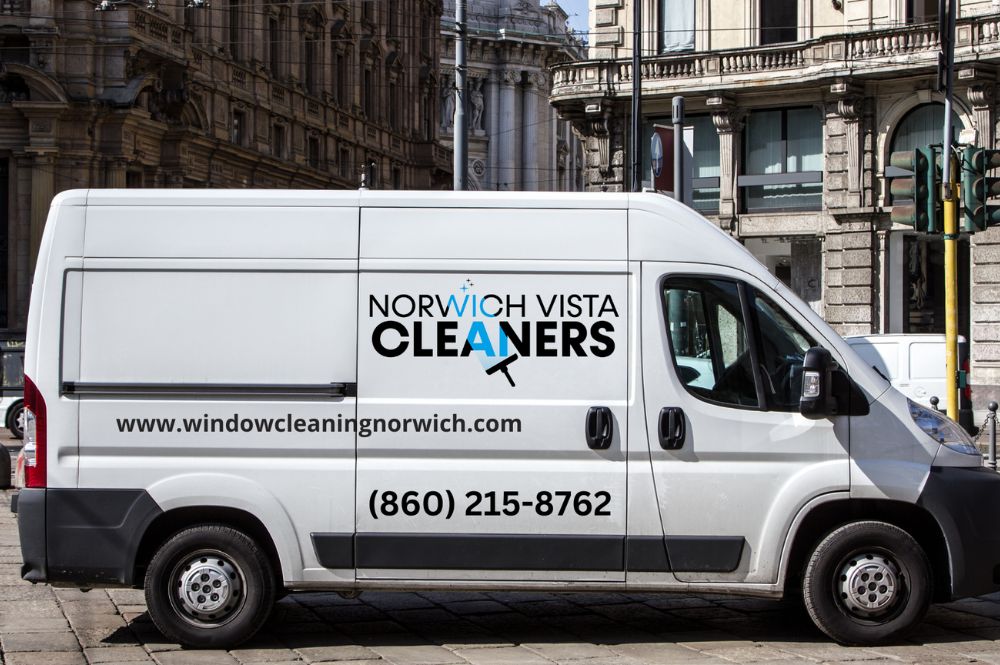A van featuring "Norwood Vista Cleaners" along with a contact number, advertising their window cleaning services.